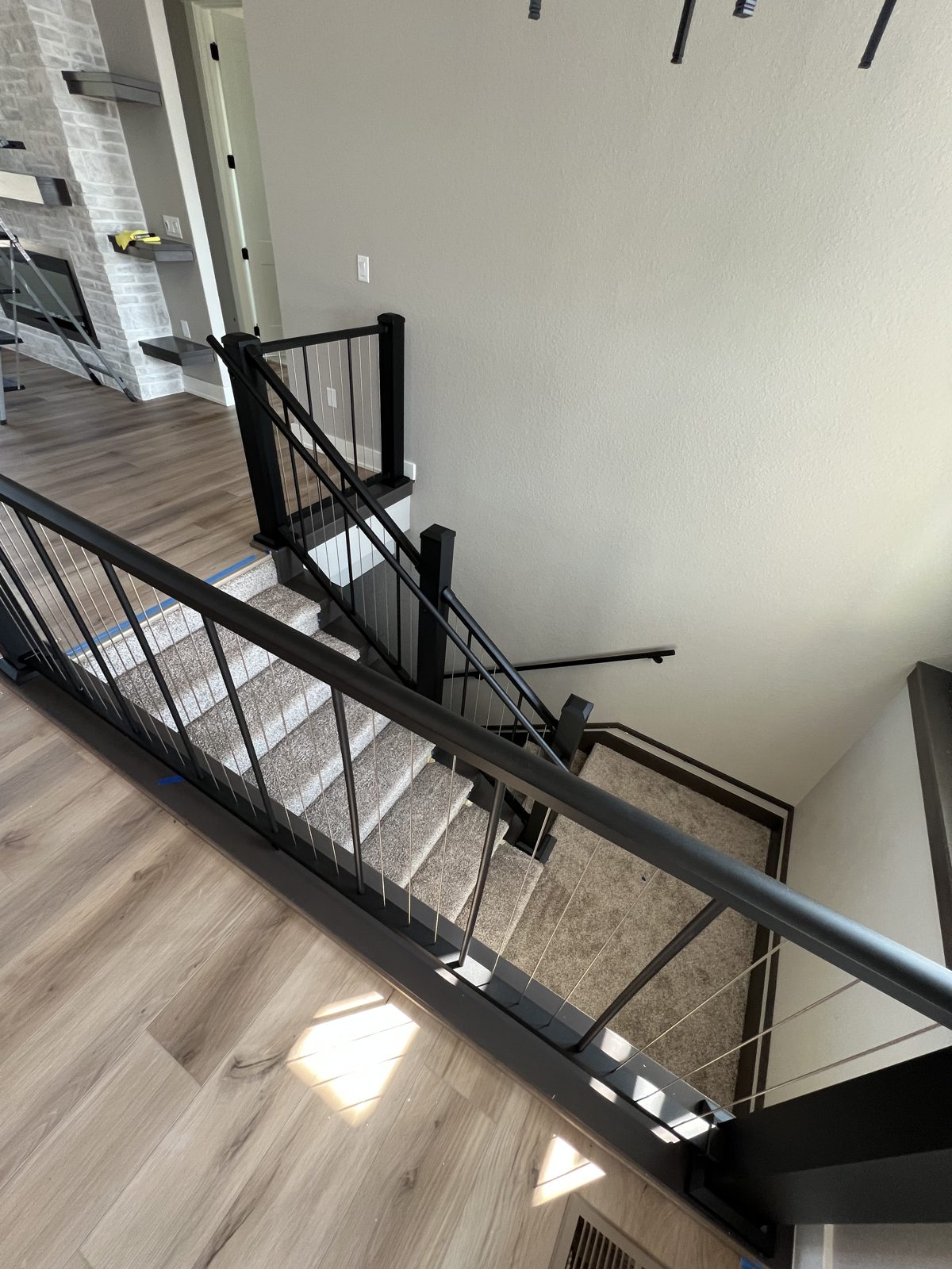 Interior staircase with black metal cable railing