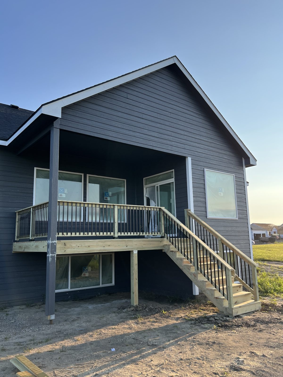Elevated deck with covered gable roof and staircase