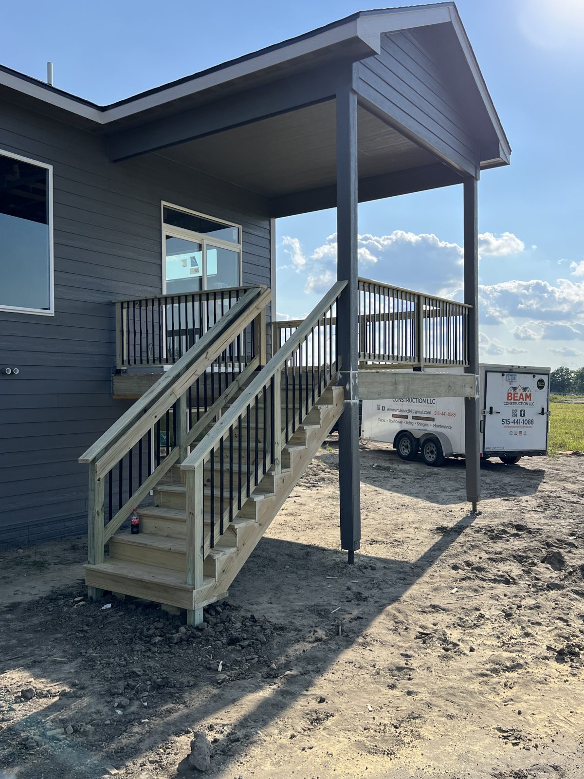 Deck staircase with black metal railing