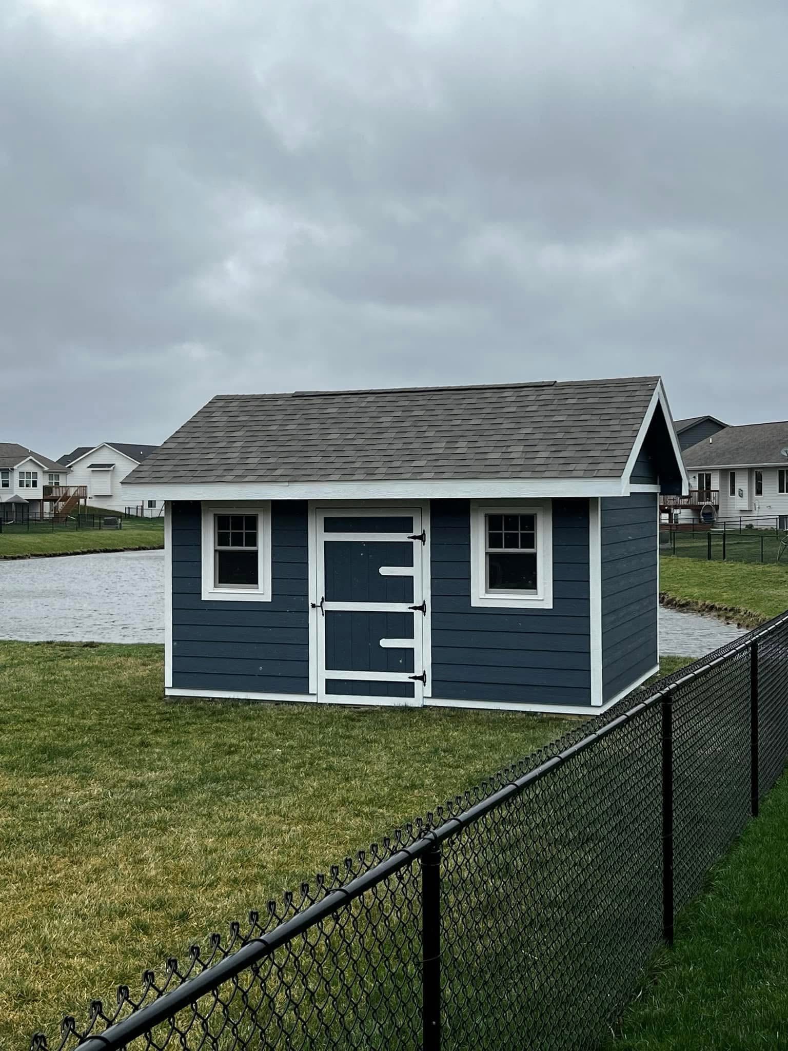 Blue shed with white trim